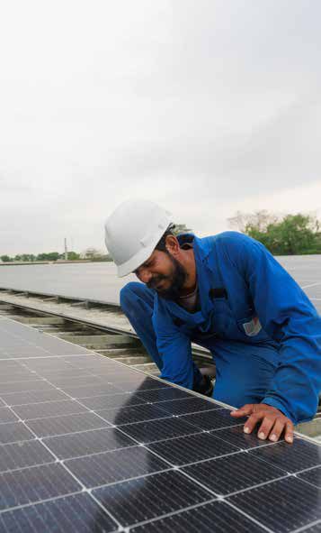 A technician installing rooftop solar panels at a MAS facility